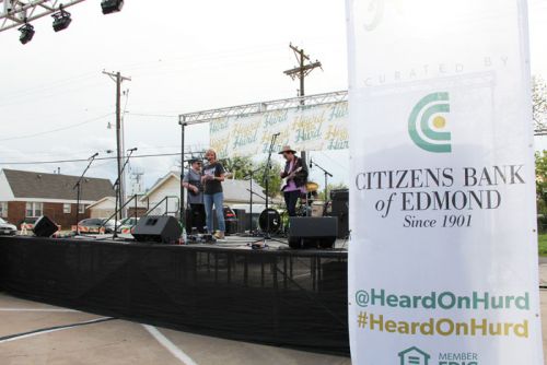 Citizens Bank of Edmond President and CEO Jill Castilla takes to the mike during the bank's "Heard On Hurd" concert and street festival. Social media makes the core of the bank's promotion of the event.
