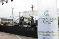 Citizens Bank of Edmond President and CEO Jill Castilla takes to the mike during the bank's "Heard On Hurd" concert and street festival. Social media makes the core of the bank's promotion of the event.